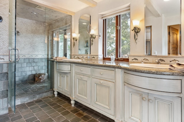 bathroom featuring tile floors, a shower with door, and double vanity