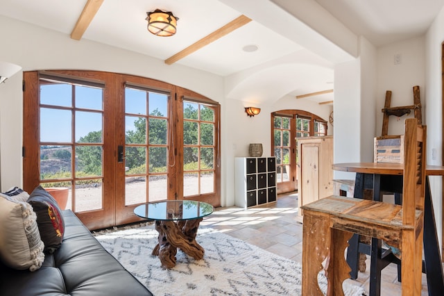 interior space featuring light tile flooring, ceiling fan, beamed ceiling, and french doors