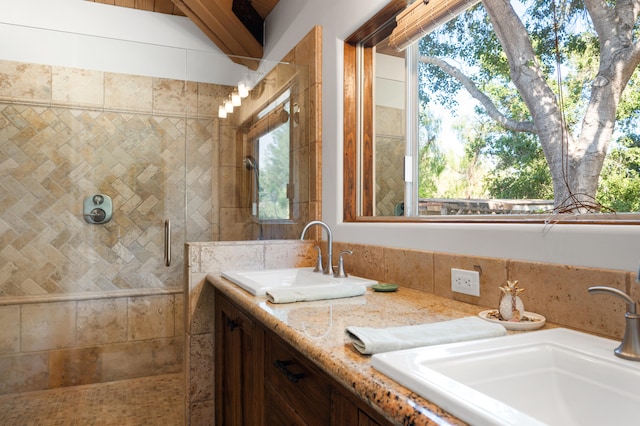 bathroom with plenty of natural light, an enclosed shower, and dual vanity