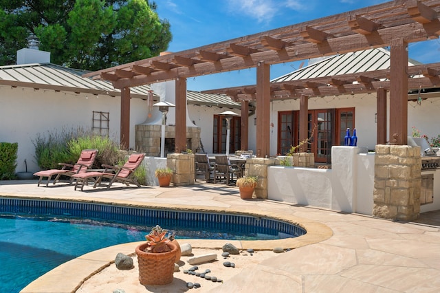 exterior space featuring exterior kitchen, a pergola, and a patio area