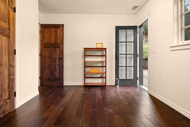 unfurnished room with dark hardwood / wood-style flooring