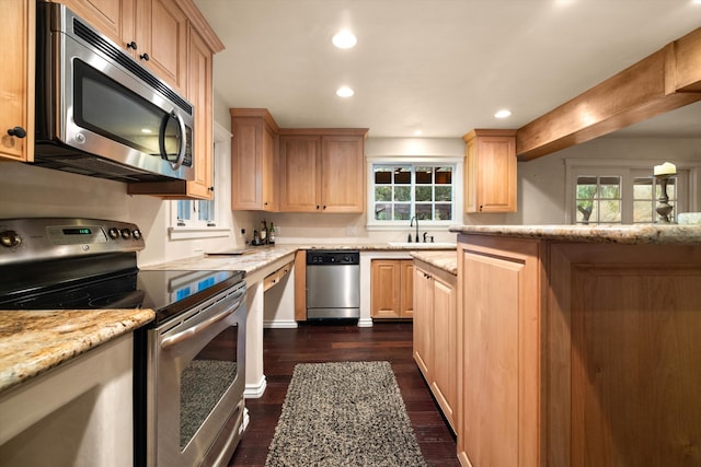 kitchen with stainless steel appliances, dark hardwood / wood-style floors, light stone counters, beamed ceiling, and sink