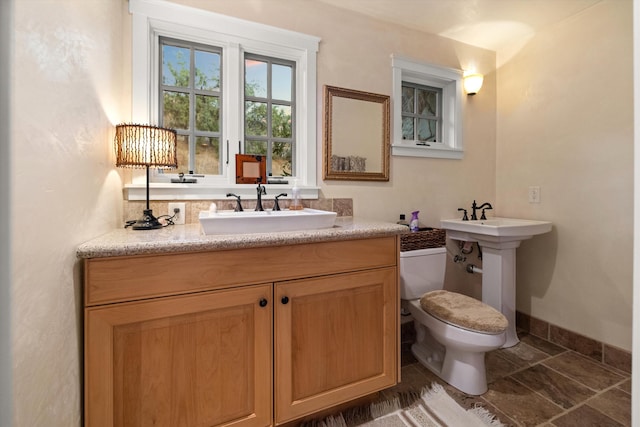 bathroom with tile flooring, sink, and toilet