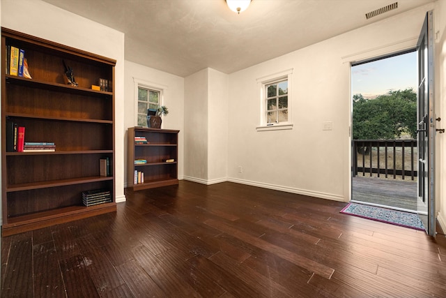 spare room with dark wood-type flooring