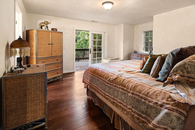 bedroom with dark hardwood / wood-style flooring and access to exterior