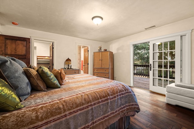 bedroom with wood-type flooring and access to outside