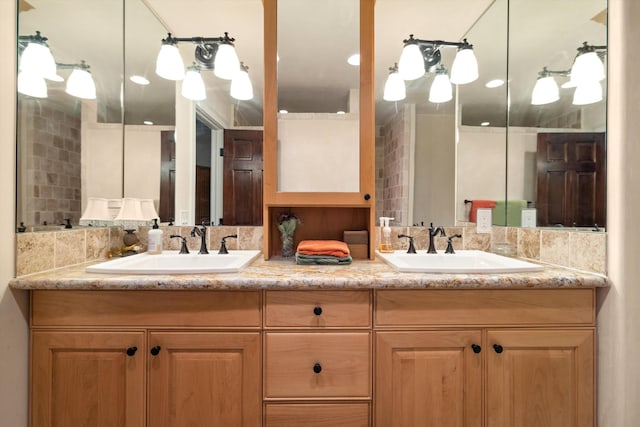 bathroom with backsplash, double sink, and large vanity