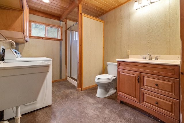 bathroom featuring washer / clothes dryer, tile flooring, toilet, and wood ceiling