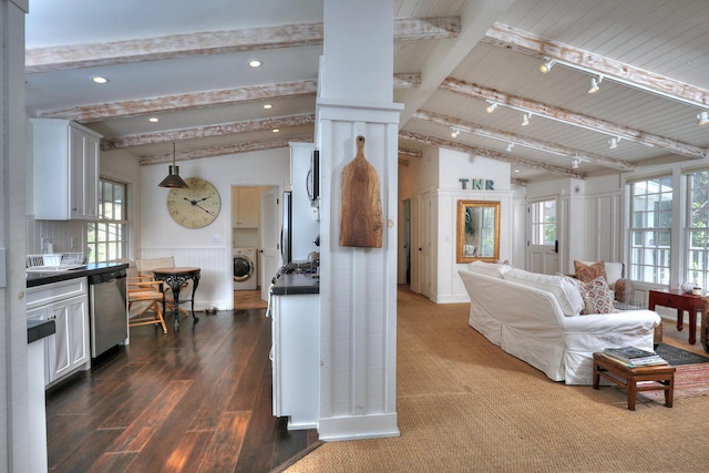 living room with plenty of natural light, vaulted ceiling with beams, washer / clothes dryer, and rail lighting