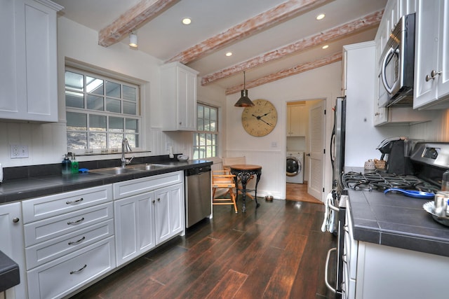 kitchen with white cabinetry, dark wood-type flooring, stainless steel appliances, washer / clothes dryer, and pendant lighting