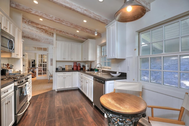 kitchen featuring vaulted ceiling with beams, dark hardwood / wood-style floors, sink, stainless steel appliances, and white cabinets