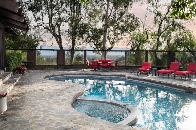 pool at dusk with a patio