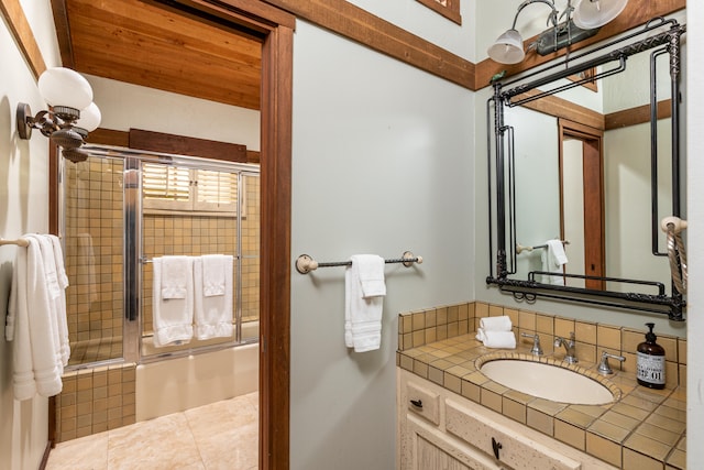 bathroom featuring tile floors, enclosed tub / shower combo, and vanity