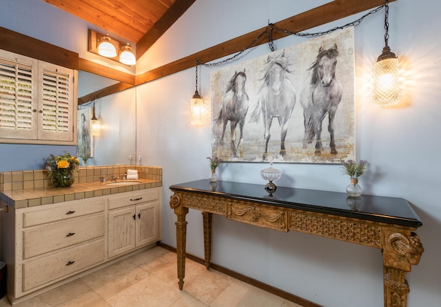 bathroom with wooden ceiling, tile flooring, large vanity, and vaulted ceiling