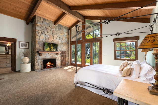 carpeted bedroom featuring beam ceiling, high vaulted ceiling, wood ceiling, and a fireplace