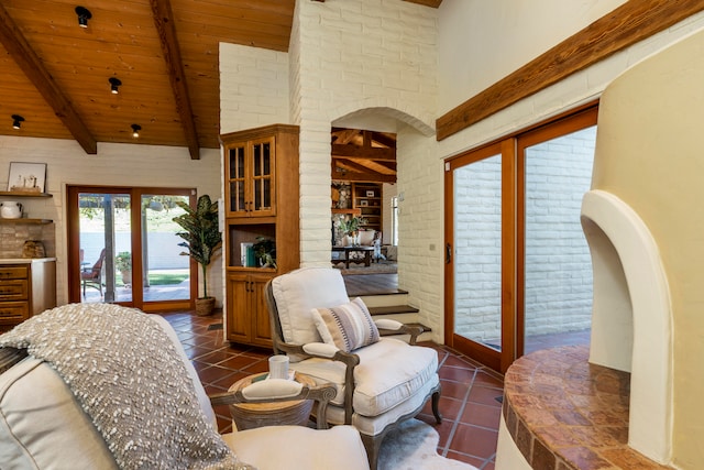 tiled living room featuring french doors, a water view, wood ceiling, and beamed ceiling