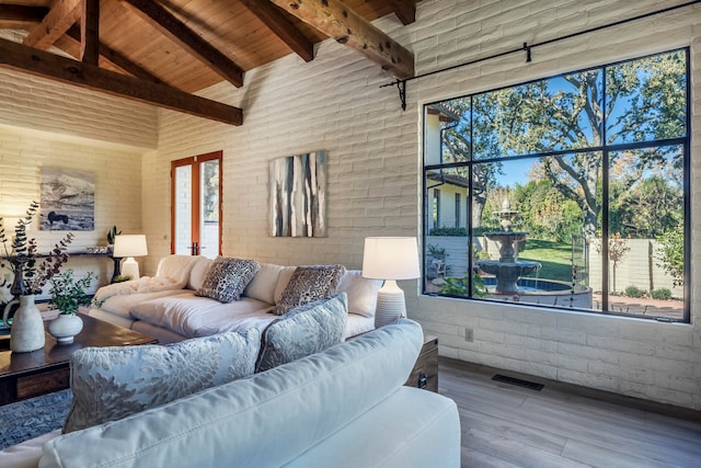 interior space with french doors, wooden ceiling, and vaulted ceiling with beams