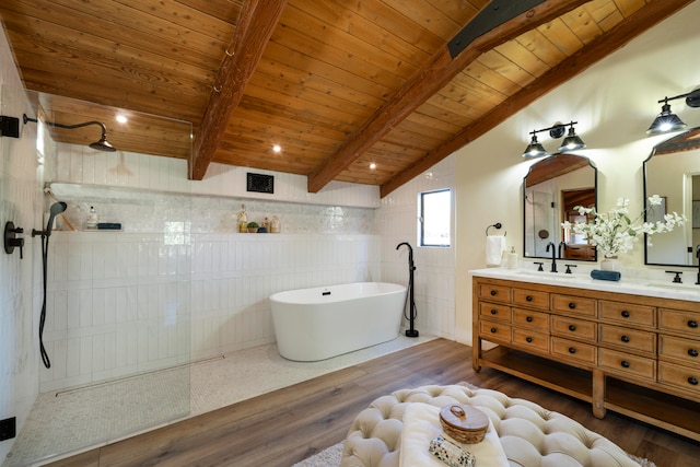 bathroom with tile walls, hardwood / wood-style flooring, wood ceiling, vanity with extensive cabinet space, and lofted ceiling with beams