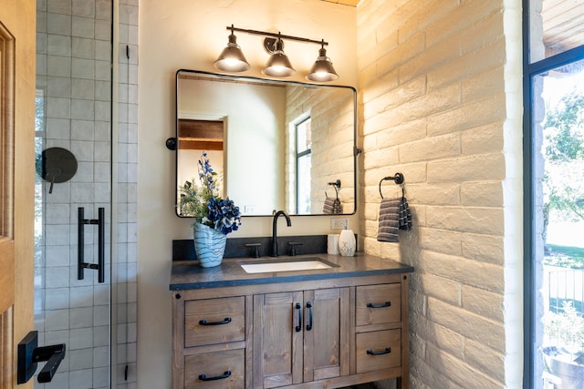 bathroom with walk in shower, brick wall, and vanity