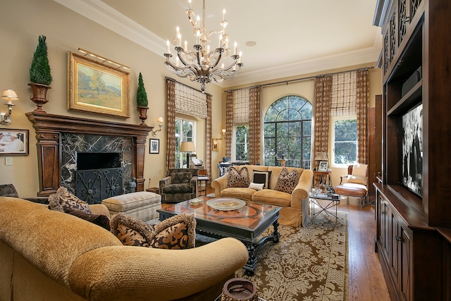 living room with a notable chandelier, dark hardwood / wood-style floors, a high end fireplace, and ornamental molding