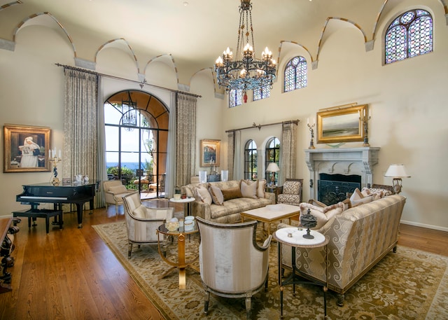 living room with an inviting chandelier and dark wood-type flooring