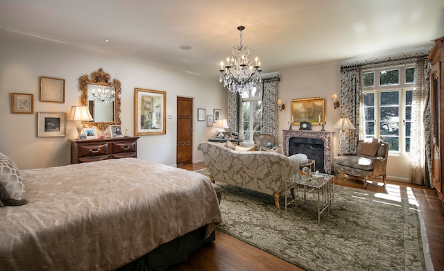 bedroom with ornamental molding, a notable chandelier, and dark hardwood / wood-style floors