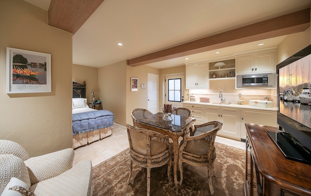 dining space with sink and light tile floors