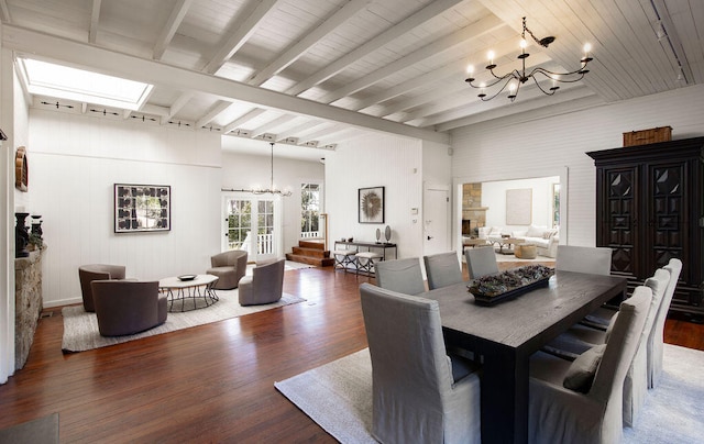 dining room featuring beamed ceiling, dark hardwood / wood-style floors, and an inviting chandelier