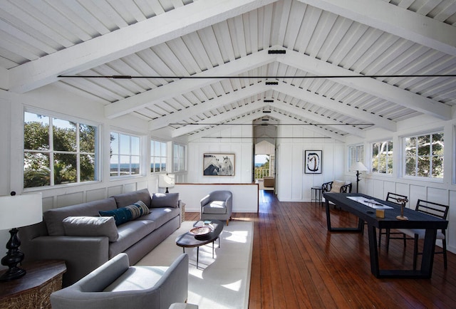 living room with lofted ceiling with beams, dark hardwood / wood-style flooring, and plenty of natural light