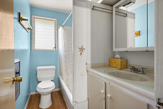 full bathroom with shower / tub combo, hardwood / wood-style floors, large vanity, and toilet