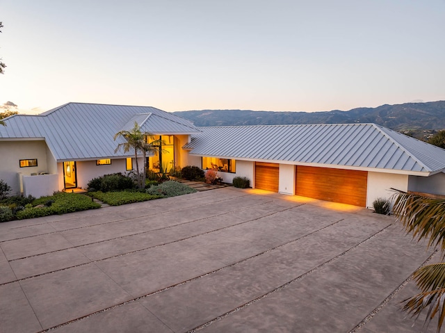 view of front of home with a garage and a mountain view