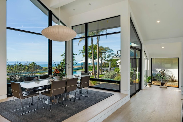 sunroom / solarium with a water view