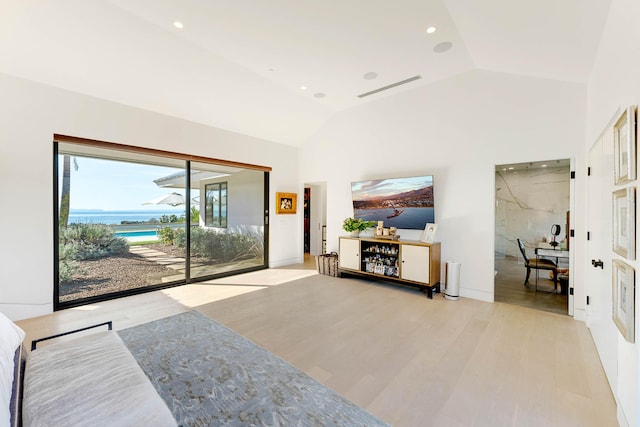 living room with light hardwood / wood-style flooring and vaulted ceiling