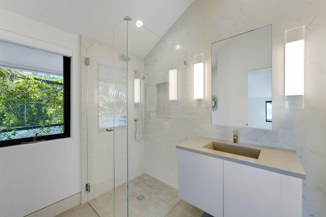 bathroom featuring lofted ceiling, vanity, tile patterned flooring, and an enclosed shower