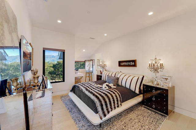 bedroom featuring light hardwood / wood-style flooring and vaulted ceiling