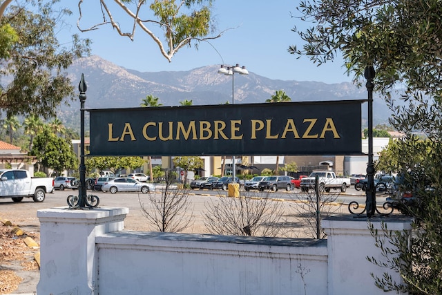 community sign with a mountain view