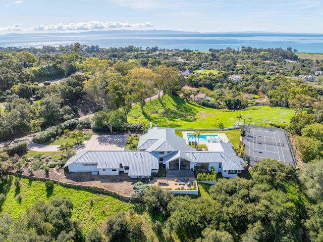 birds eye view of property with a water view