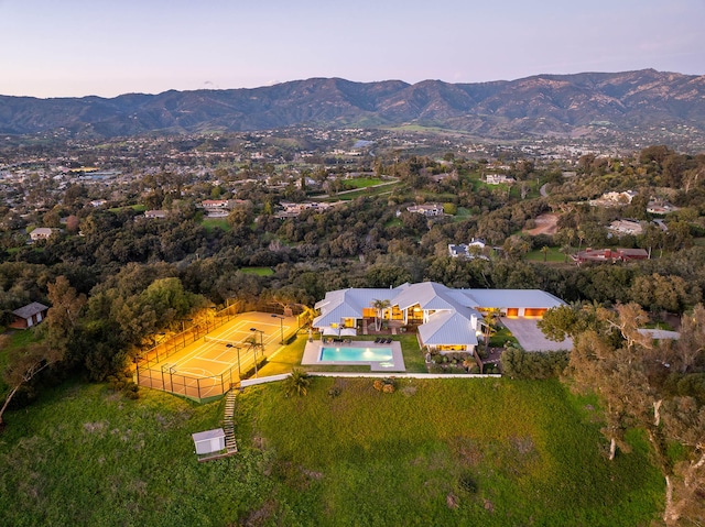 aerial view at dusk featuring a mountain view