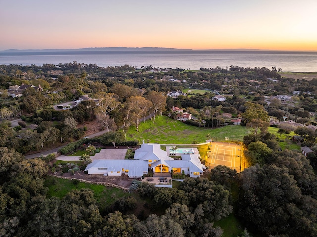 aerial view at dusk with a water view