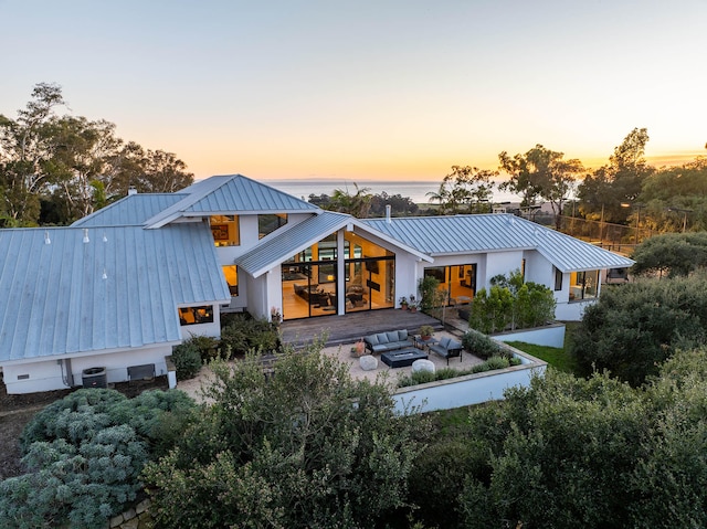 back house at dusk with a patio