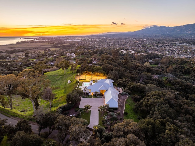 aerial view at dusk with a water and mountain view