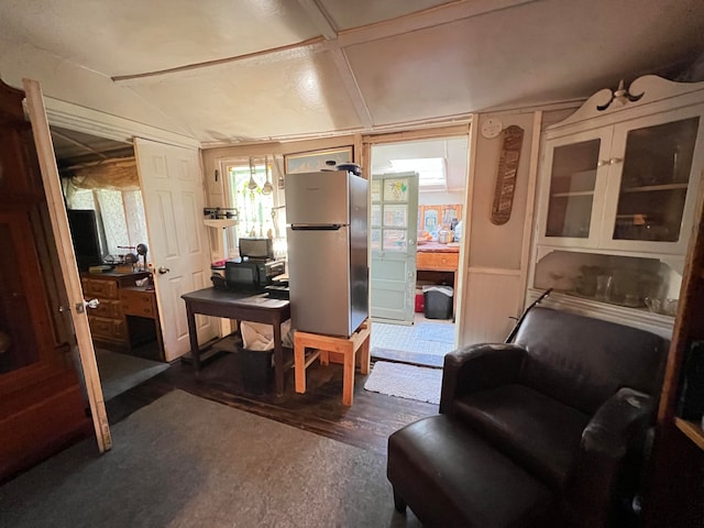 office featuring vaulted ceiling and dark wood-type flooring