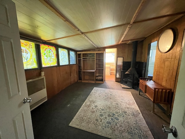 interior space featuring a wood stove and lofted ceiling