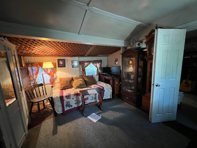 bedroom with dark colored carpet and vaulted ceiling