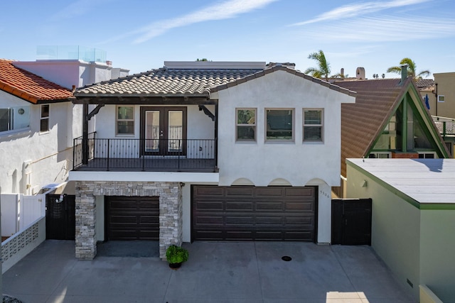 view of front of home with a balcony and a garage