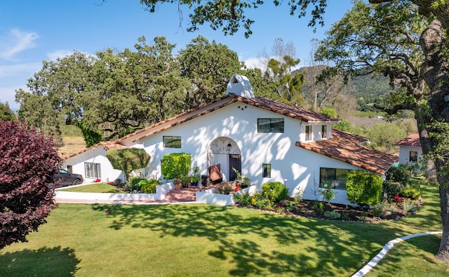 mediterranean / spanish-style home featuring a front lawn