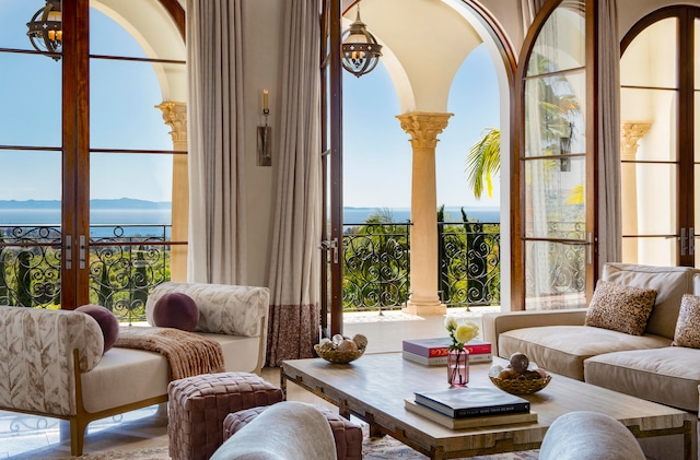 living room featuring french doors and a water view