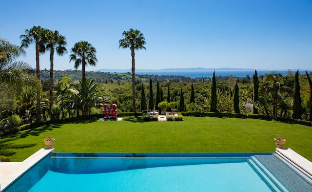 view of pool featuring a yard