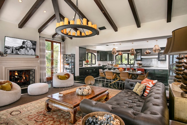 living room featuring beamed ceiling, high vaulted ceiling, and sink