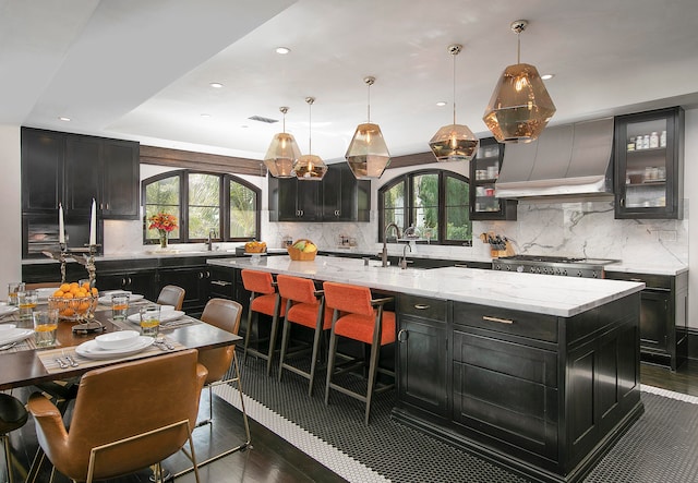 kitchen with plenty of natural light, tasteful backsplash, and a large island